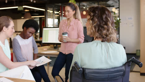 portrait of caucasian businesswoman in wheelchair with diverse colleagues at meeting, slow motion