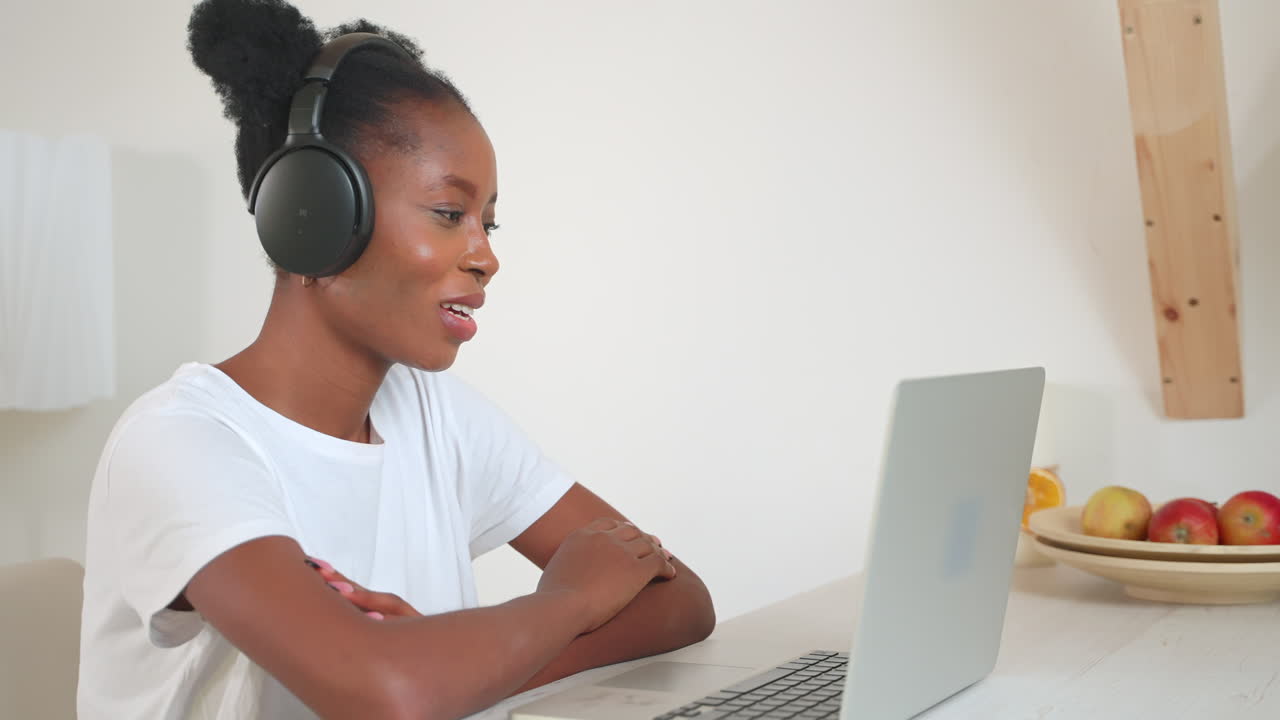 Woman Working on Laptop with Headphones