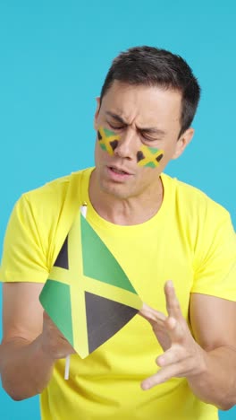 man cheering for jamaica during a match that is lost