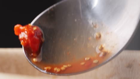 spicy red chili sauce on spoon