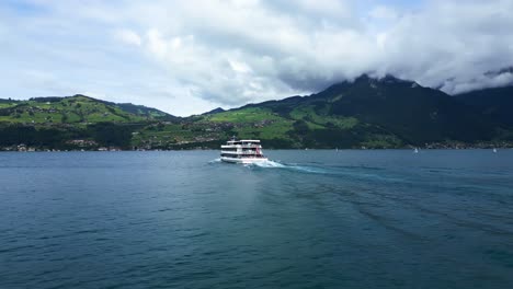 pan drone shot of a big white boat on thun lake in switzerland in canton of bern