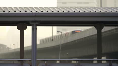 train seen through pillars of footbridge