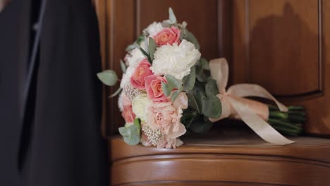 a bridal bouquet of pink and white roses and carnations with eucalyptus