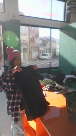 person shopping for clothing at a laundromat