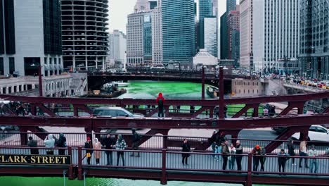 hyperlapse of white caucasian male wearing red jacket on bridge during saint patricks day in chicago