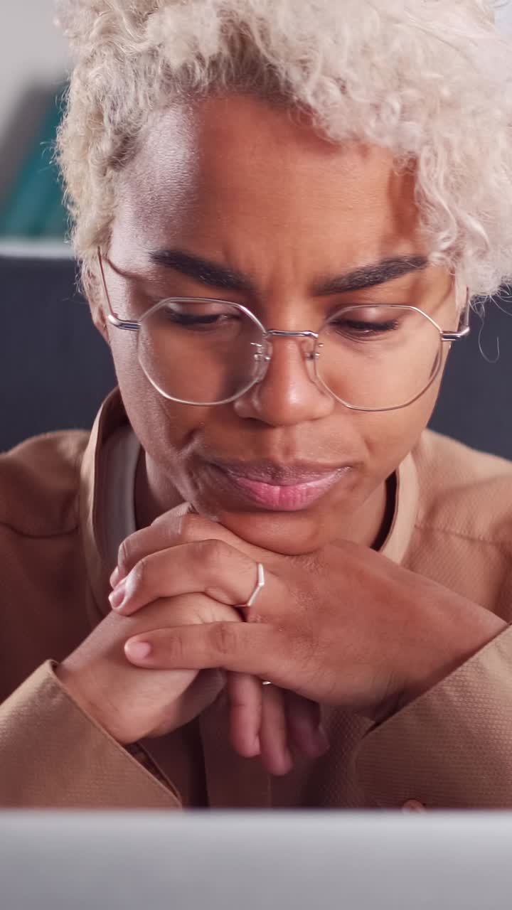 Young thoughtful african american woman is nervous working with computer