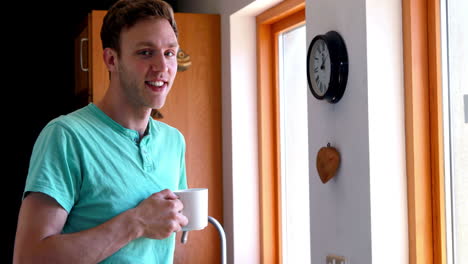 Handsome-young-man-having-coffee-looking-out-the-window