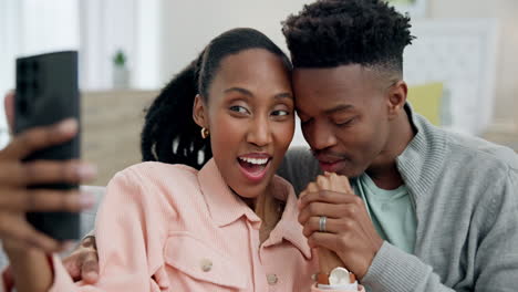 Couple,-happy-selfie-and-wedding-ring-on-home-sofa