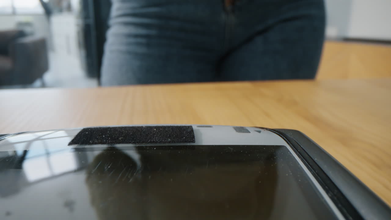 Closeup credit card machine for money transaction at table. Woman near terminal