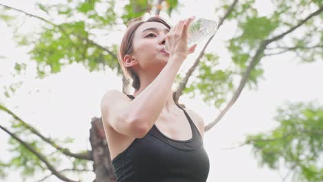 woman drinking water outdoors