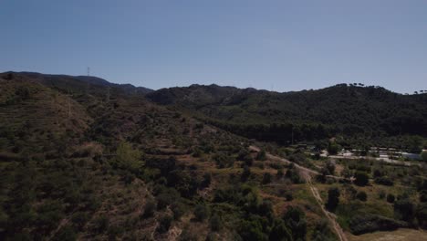 Varias-Casas-Se-Encuentran-En-Medio-Del-Encantador-Paisaje,-Rodeadas-De-Frondosos-Bosques,-Florecientes-Jardines-Y-Majestuosas-Montañas