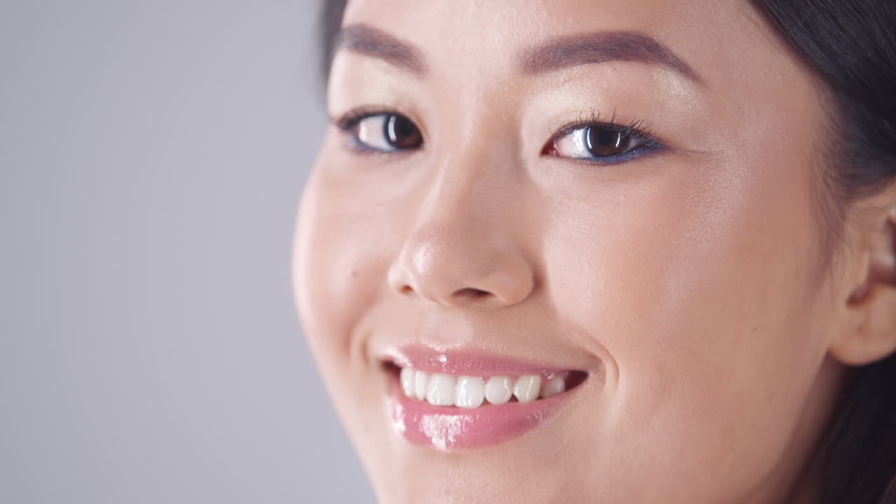 Close-up portrait of a smiling woman with makeup