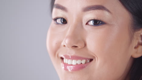 close-up portrait of a smiling woman with makeup