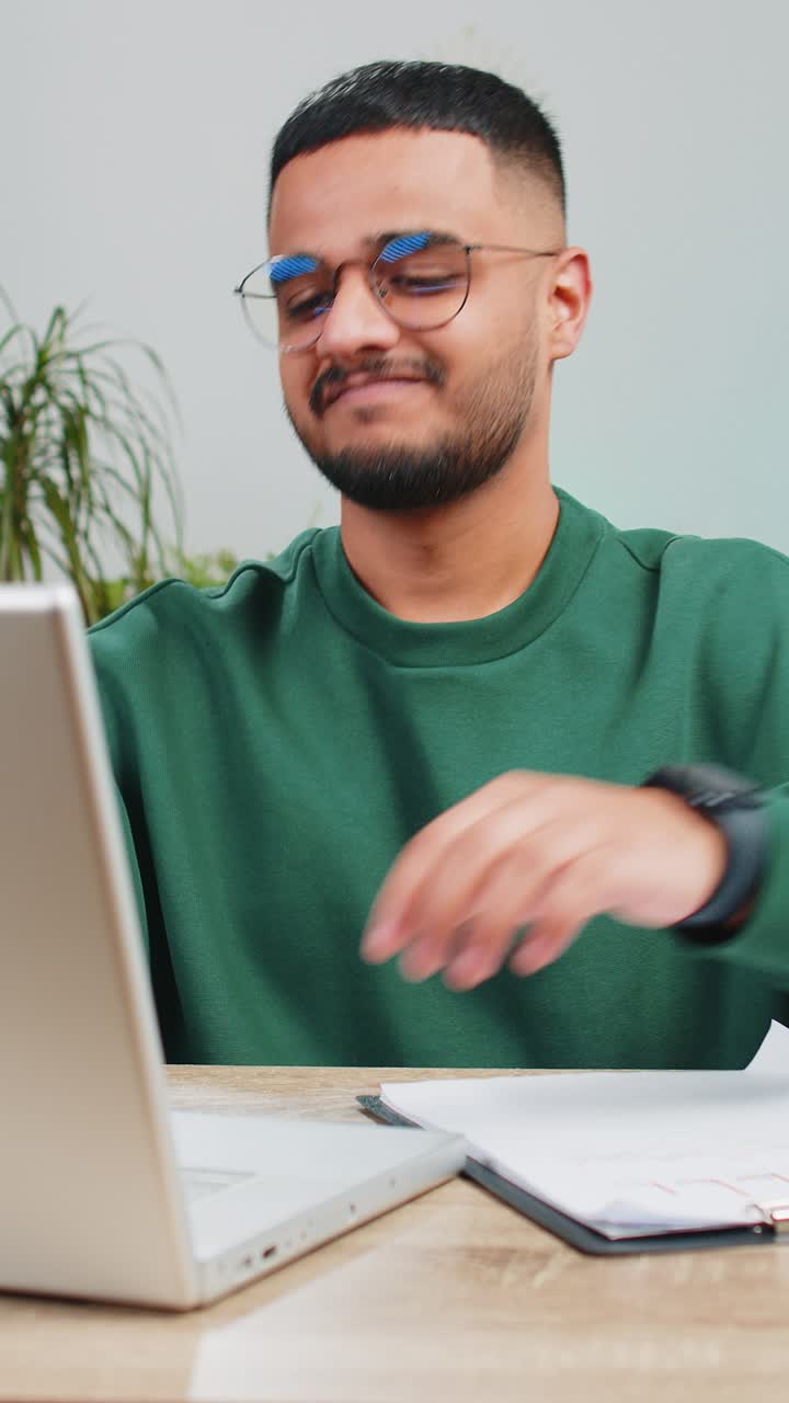 Happy man freelancer work with documents from home analyzing information prepare financial report