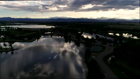 Be-humbled-in-awe-at-this-sunset-taken-by-drone-of-the-Rocky-Mountains-with-reflections-in-the-lakes-below