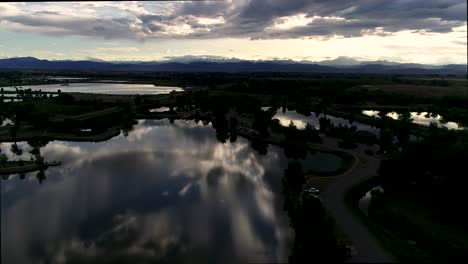 be humbled in awe at this sunset taken by drone of the rocky mountains with reflections in the lakes below