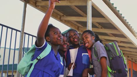 schoolgirls taking selfies in the playground at a township school 4k