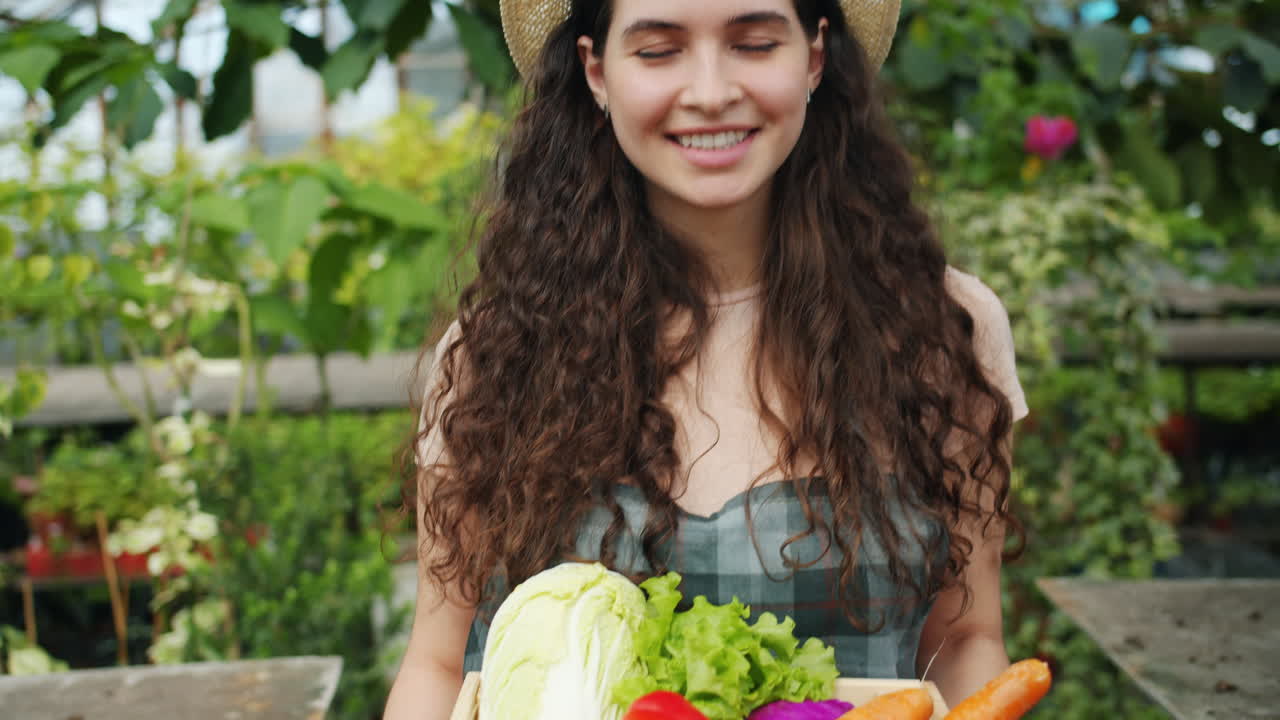 Woman farmer smiling in a greenhouse