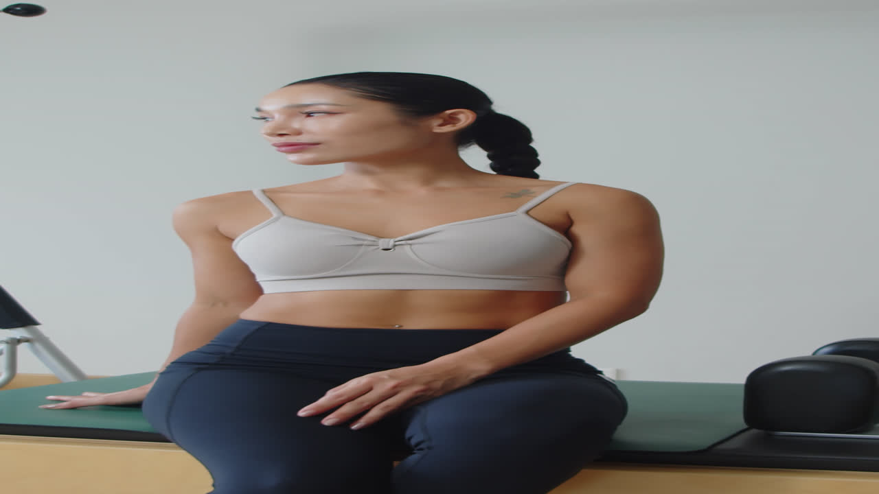 Portrait of Cheerful Sportswoman Posing after Training Indoors