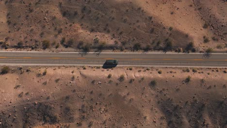 van driving along straight desert road