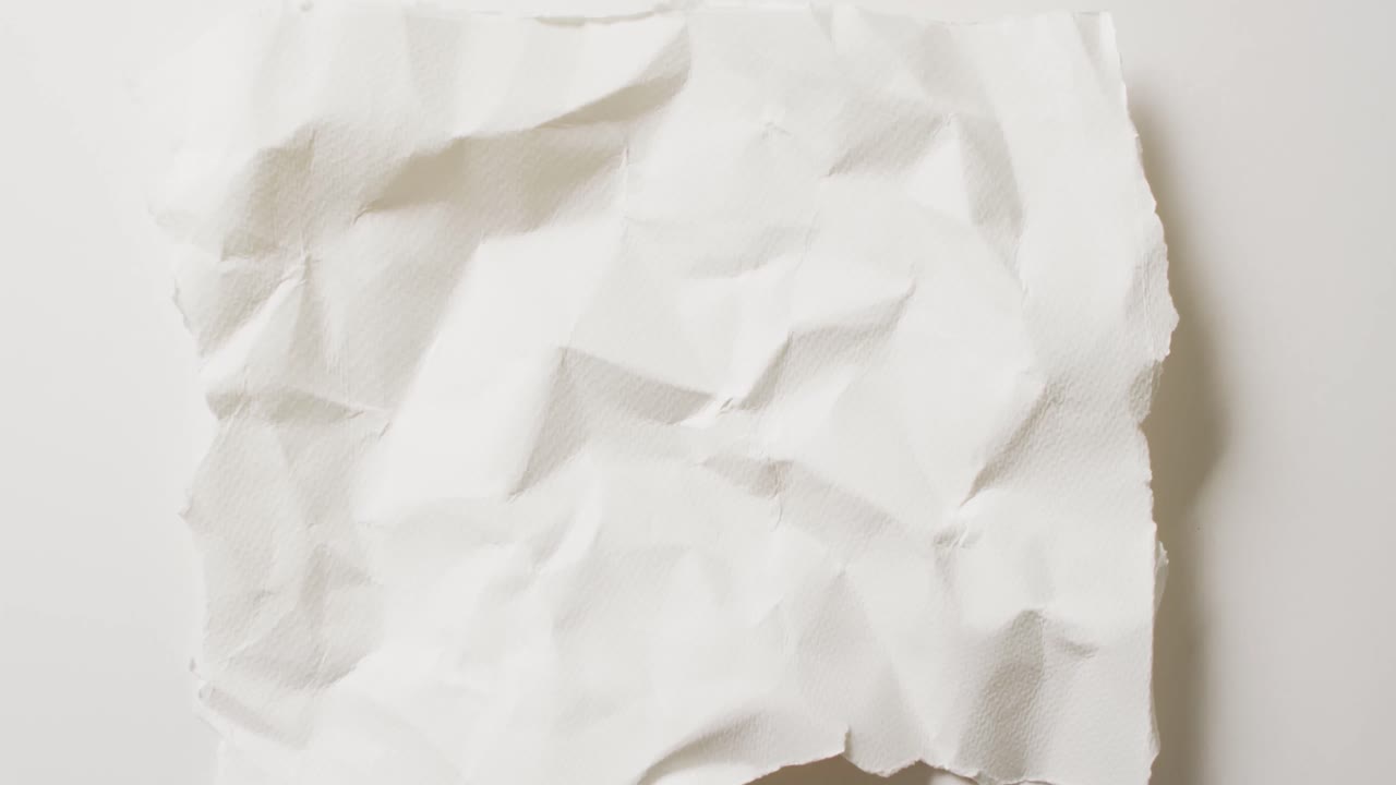 Video of close up of crumpled white paper texture on white background