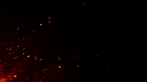 beautiful burning hot sparks rising from large fire in night sky. abstract isolated fire glowing particles on black background flying up. looped 3d animation.