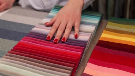 hand touching colorful fabric swatches