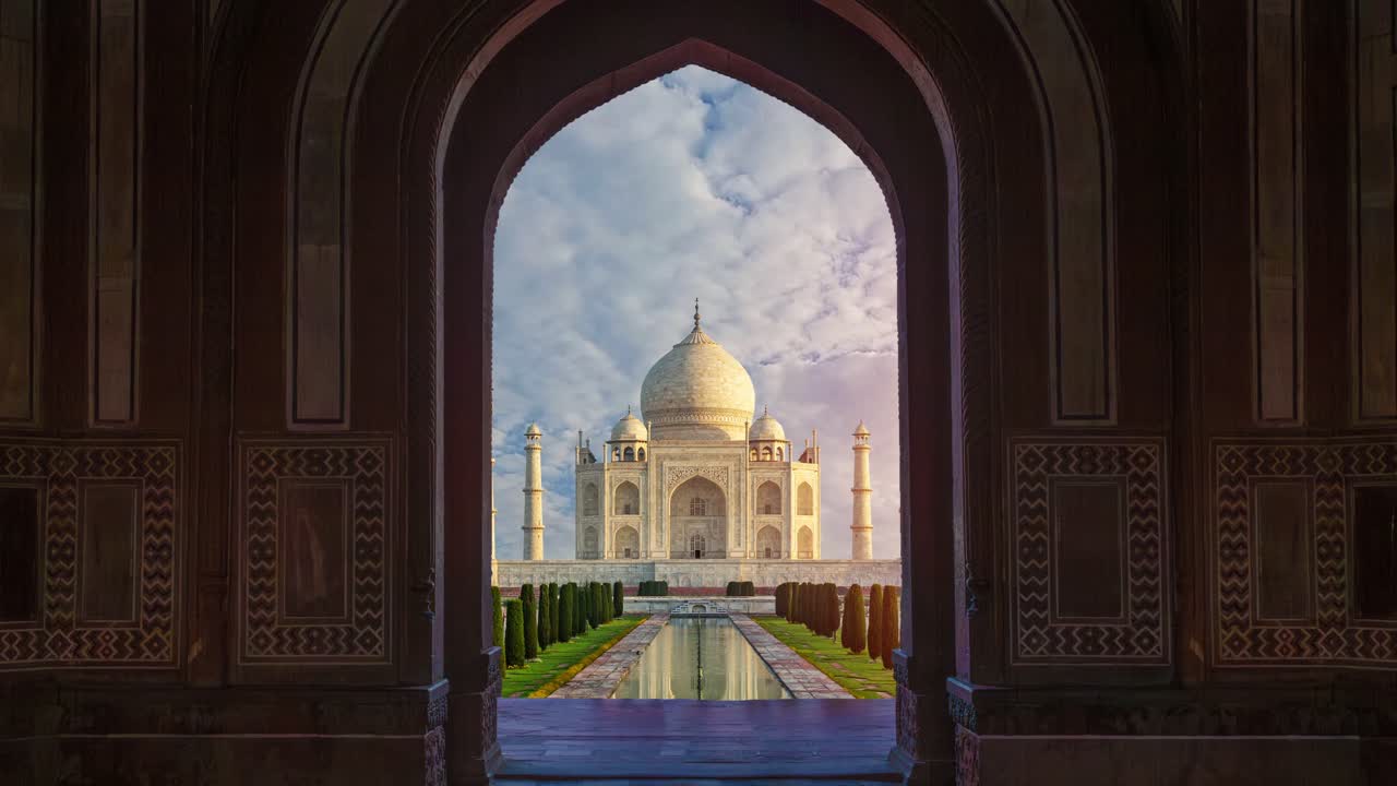 Approaching the Majestic Taj Mahal: A Slow Zoom Through a Grand Archway Reveals the Intricate Details and Timeless Beauty of India's Iconic Landmark in the Morning