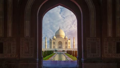 approaching the majestic taj mahal: a slow zoom through a grand archway reveals the intricate details and timeless beauty of india's iconic landmark in the morning