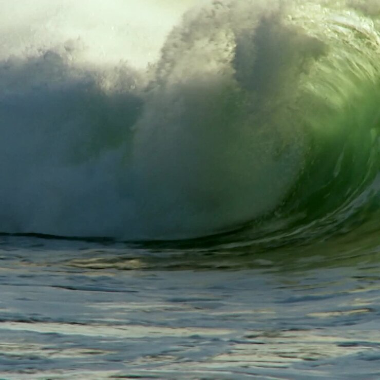 Large waves as they crest and break in slow motion 1
