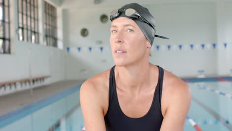 caucasian female swimmer athlete in a swimming pool setting