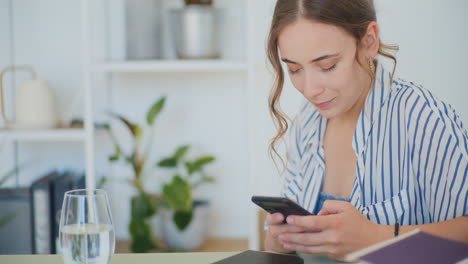 Woman-Texting-on-Sofa