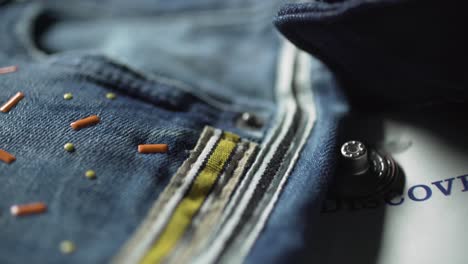 closeup of buttons - denim jeans in a textiles factory