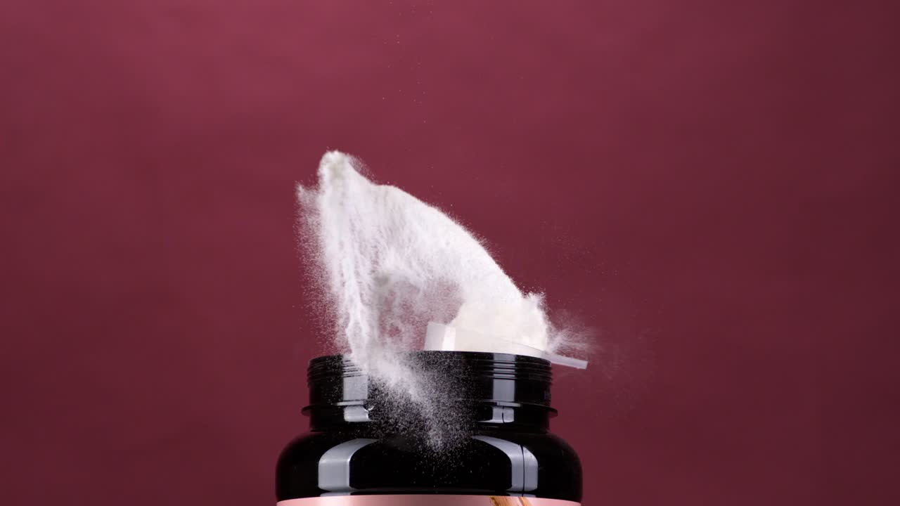 Protein powder spoon hit the top of the container in super slow motion