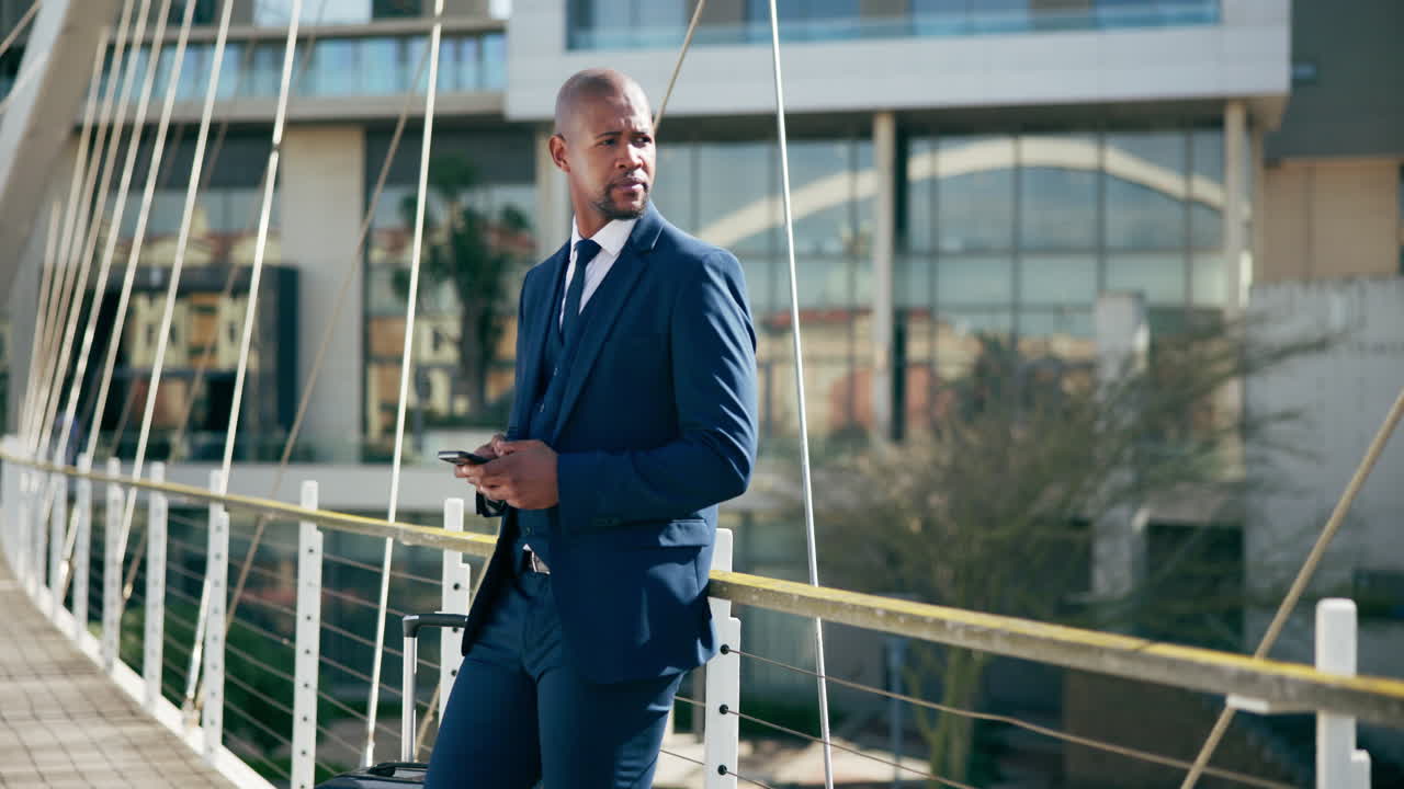 Businessman using smartphone on a bridge in a city