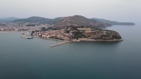 Aerial-view-of-medieval-castle-and-Arvanitia-beach-in-Nafplio,-Peloponesse,-Greece