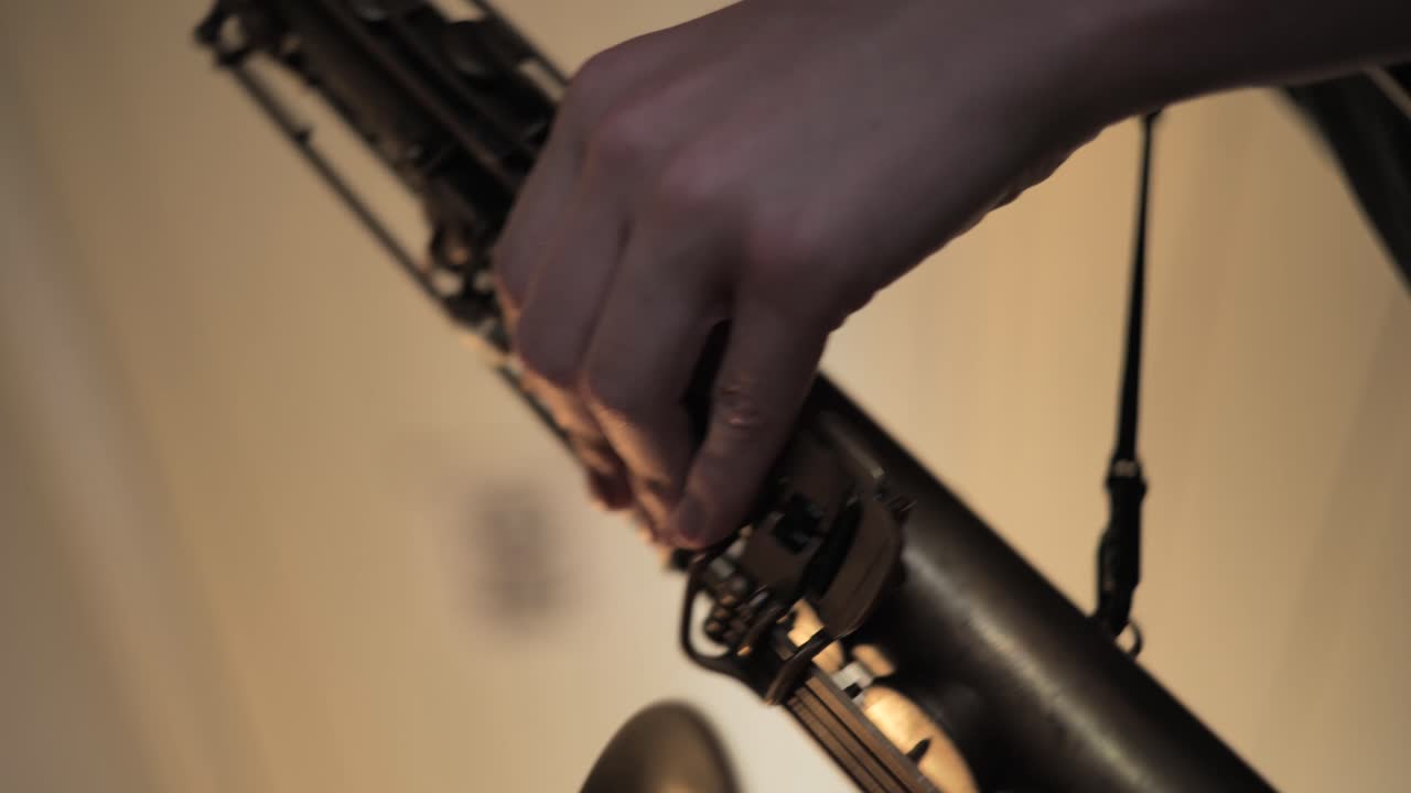 Saxofone, close up of hand playing music on a saxofone