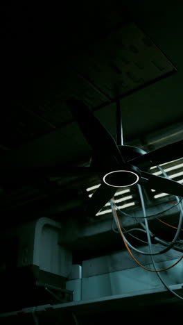 a black ceiling fan in a dark room