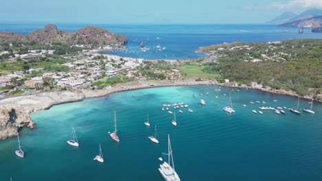 boats at vulcano island beaches and tyrrhenian sea at aeolian islands, italy - aerial 4k