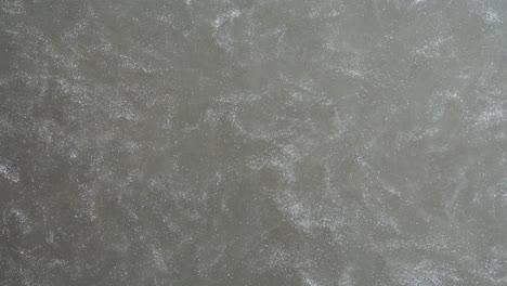 grey surface with scattered spots