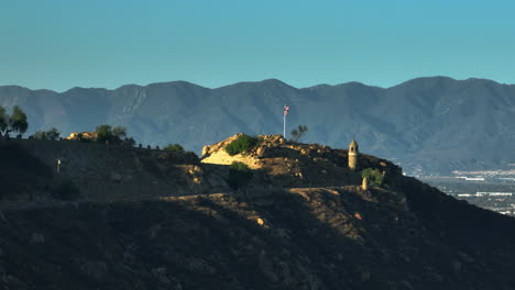 aerial view around the castle and us flag on top of mount rubidoux, sunset in usa