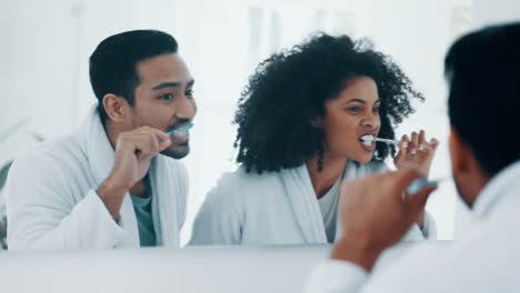 Interracial-couple,-brushing-teeth