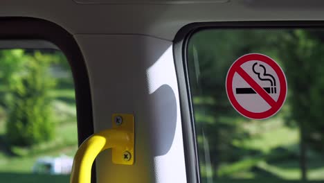 no smoking sign on a bus window