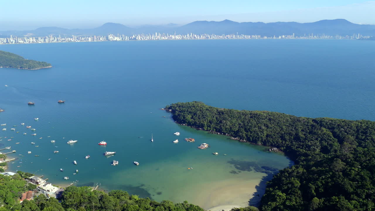 Brazilian paradise Caixa D’aço Beach with boats and vibrant shoreline scenery, Itapanema, Santa Catarina