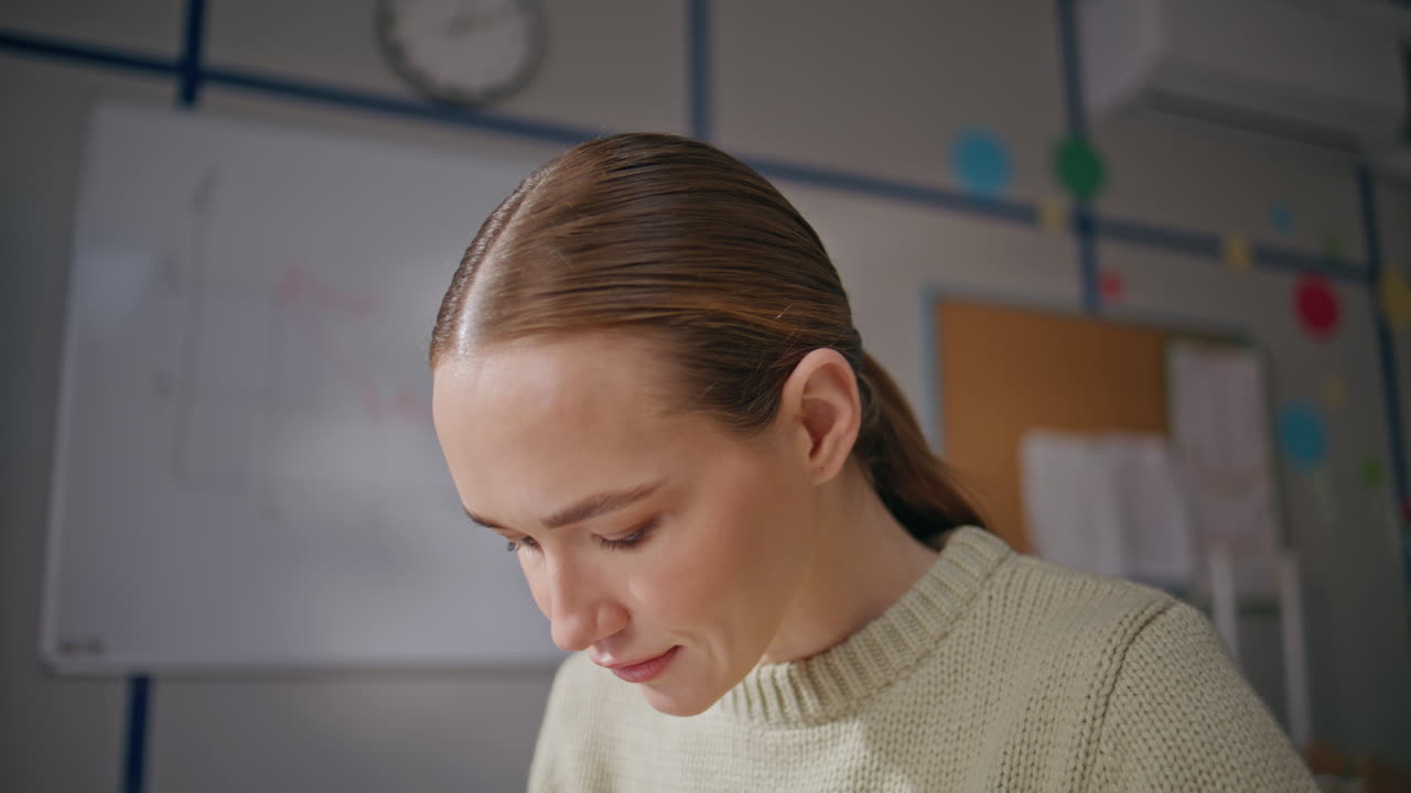 Friendly girl working school at light day closeup.Teacher sitting algebra class