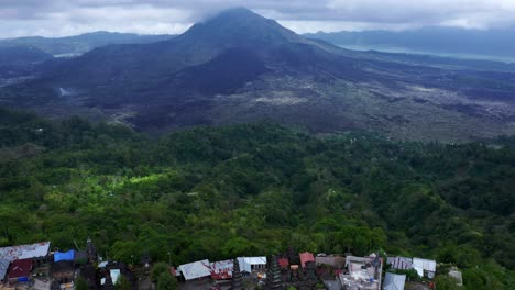 Revealing-Mount-Batur-reaching-clouds-and-Hindu-temple-in-Kintamani-village---Bali,-Indonesia