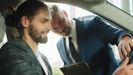 man discussing car purchase with salesman