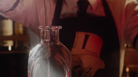 Bartender Pouring Liquid into a Bottle