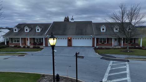 aerial rising shot of retirement home villas behind street lamp and road sign