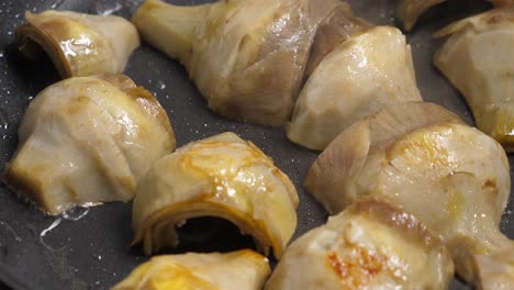 cocinando alcachofes en la sartén. primer plano